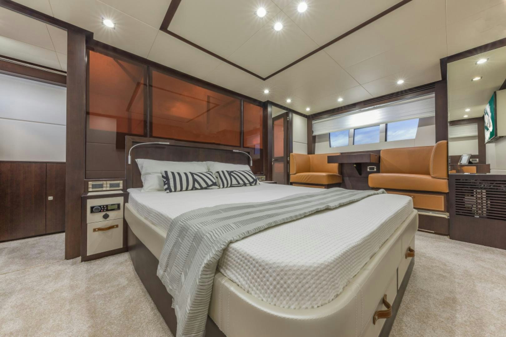 a bedroom with a bed and a chair aboard No Name Yacht for Sale