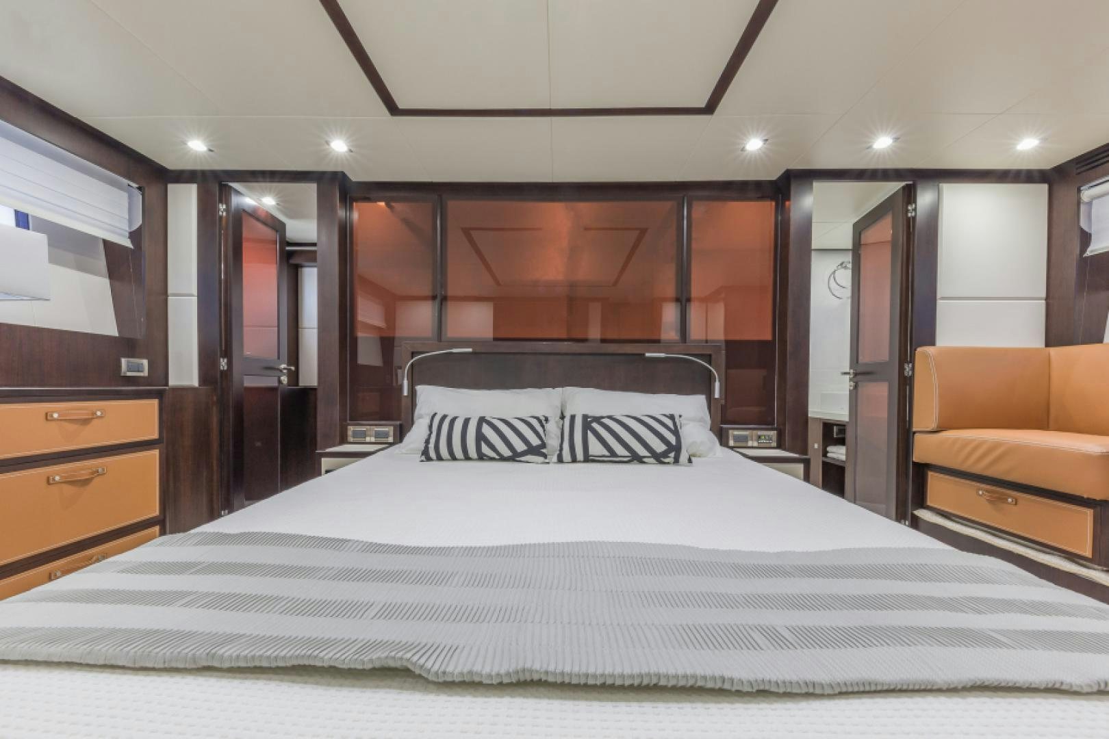 a bed with a white sheet aboard No Name Yacht for Sale