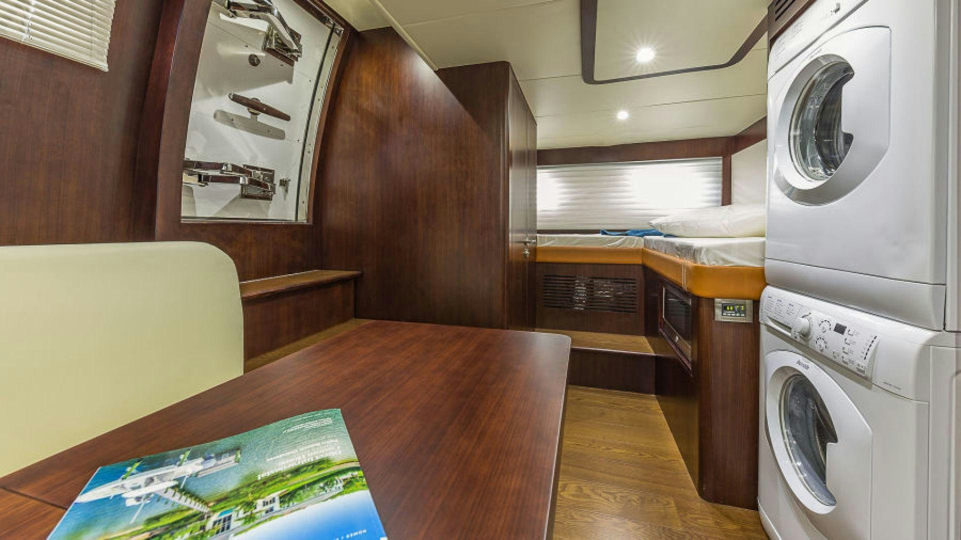 a kitchen with a table and a microwave aboard No Name Yacht for Sale