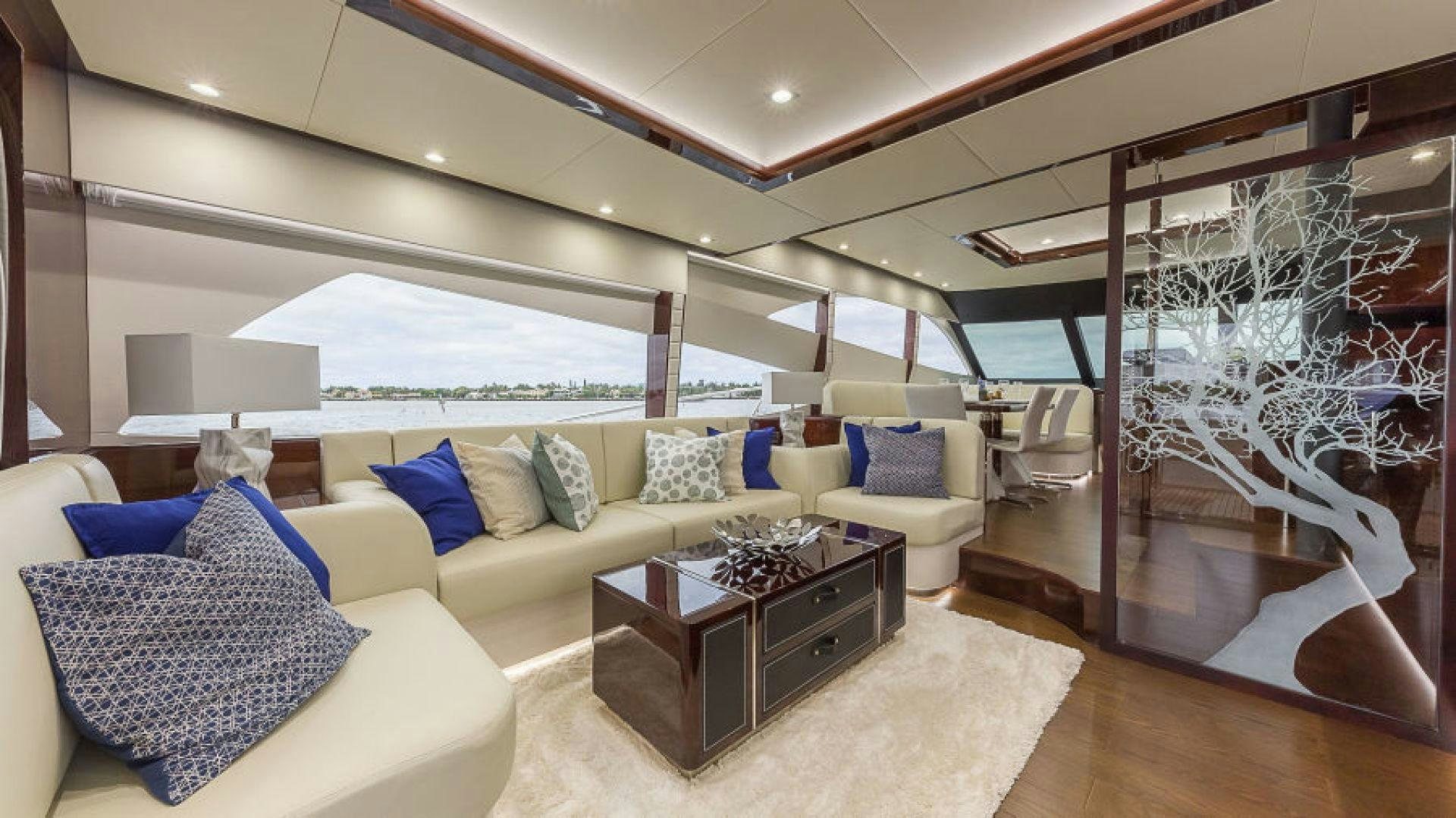 a living room with a large glass wall aboard No Name Yacht for Sale