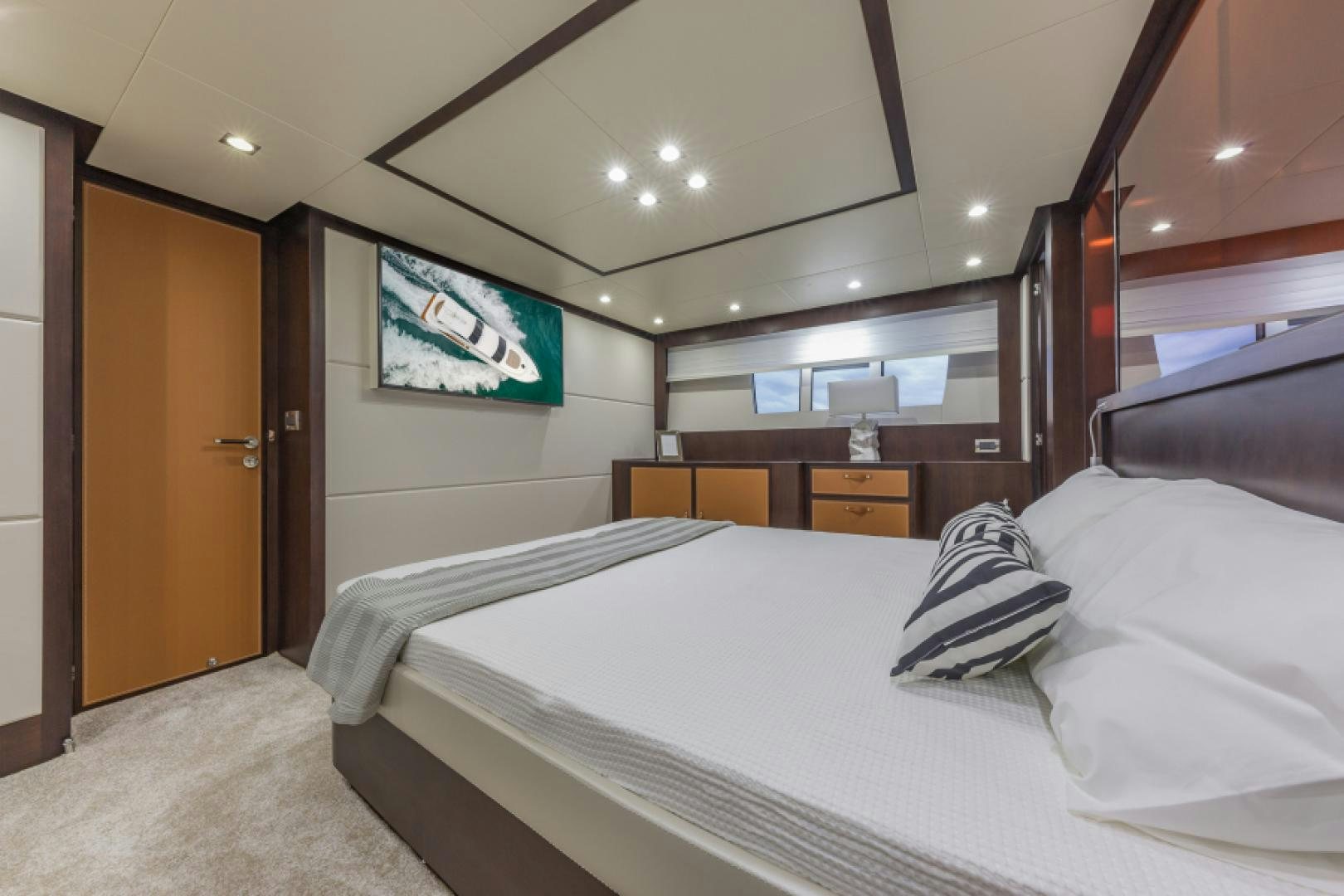 a room with a bed and a television on the wall aboard No Name Yacht for Sale