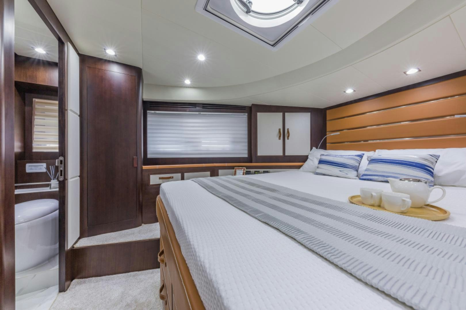 a bedroom with a bed and a closet aboard No Name Yacht for Sale