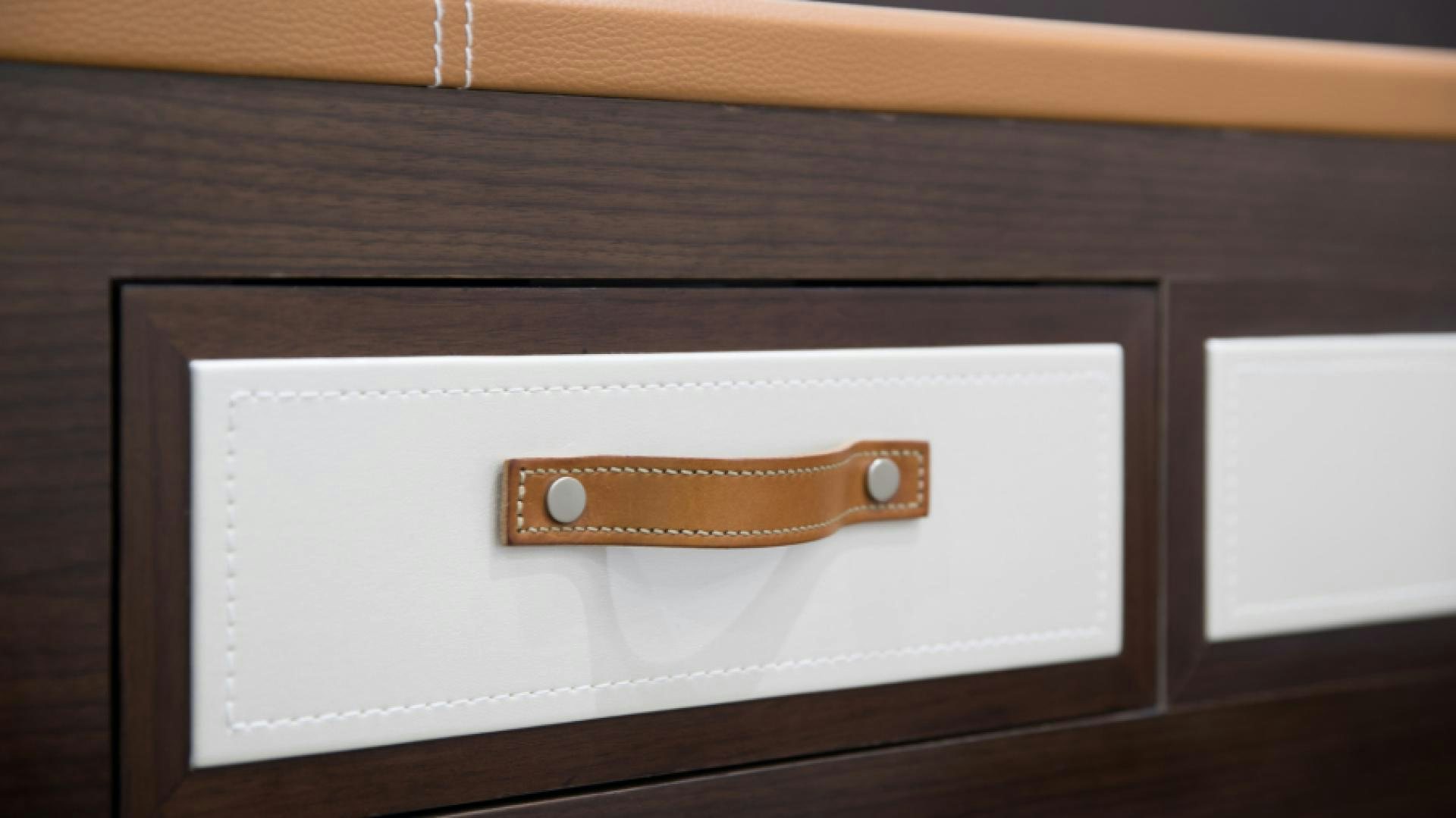 a white rectangular object with a wooden handle on a wooden surface aboard No Name Yacht for Sale