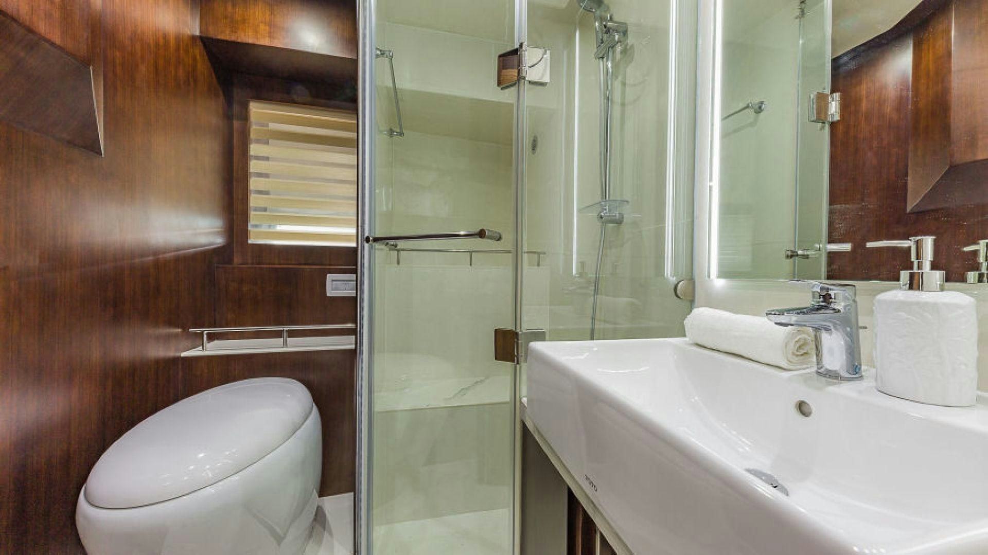 a bathroom with a glass shower door aboard No Name Yacht for Sale