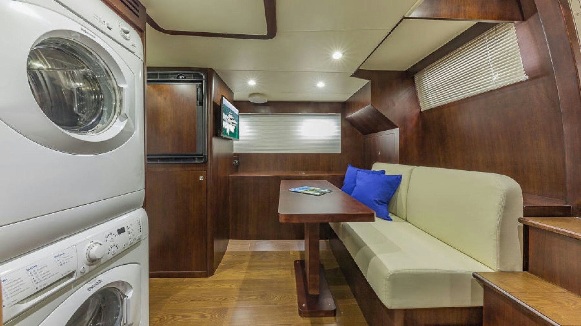 a room with a bed and a table aboard No Name Yacht for Sale