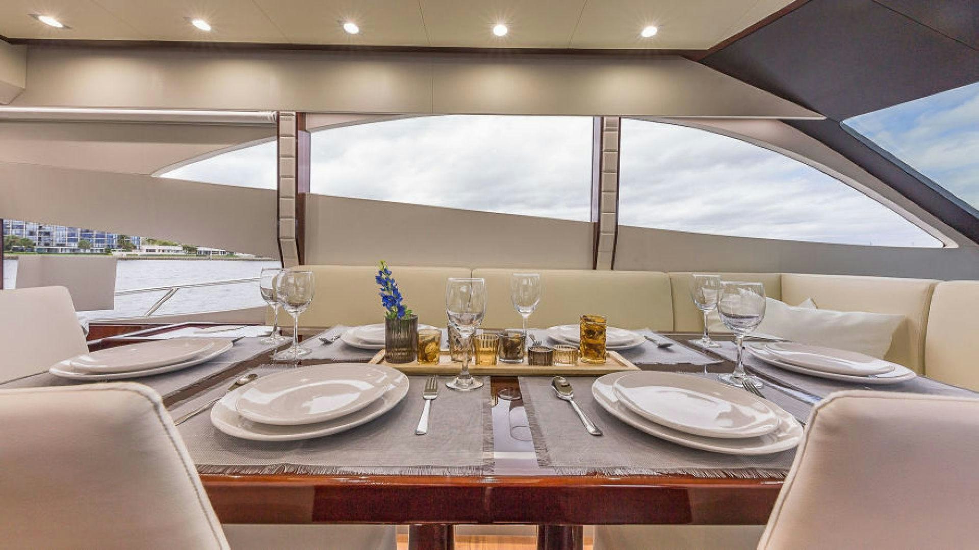 a table with plates and glasses aboard No Name Yacht for Sale