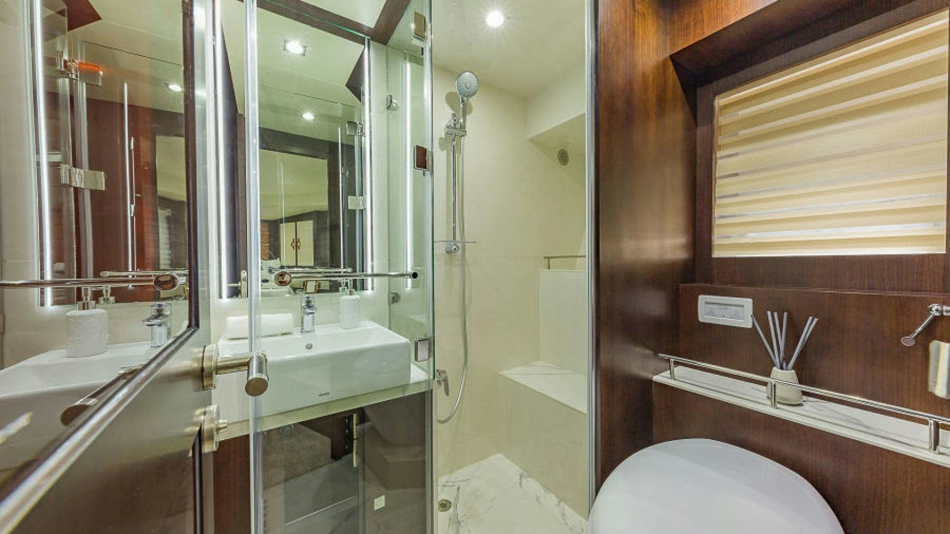 a bathroom with a large mirror aboard No Name Yacht for Sale