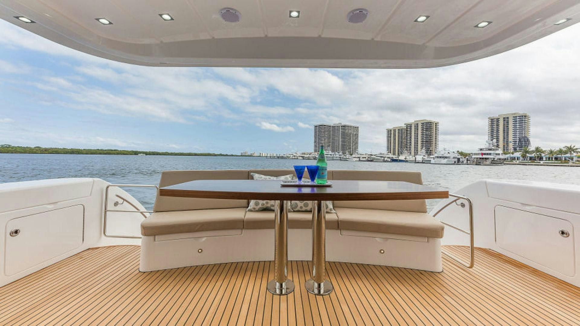 a table on a deck overlooking a body of water aboard No Name Yacht for Sale