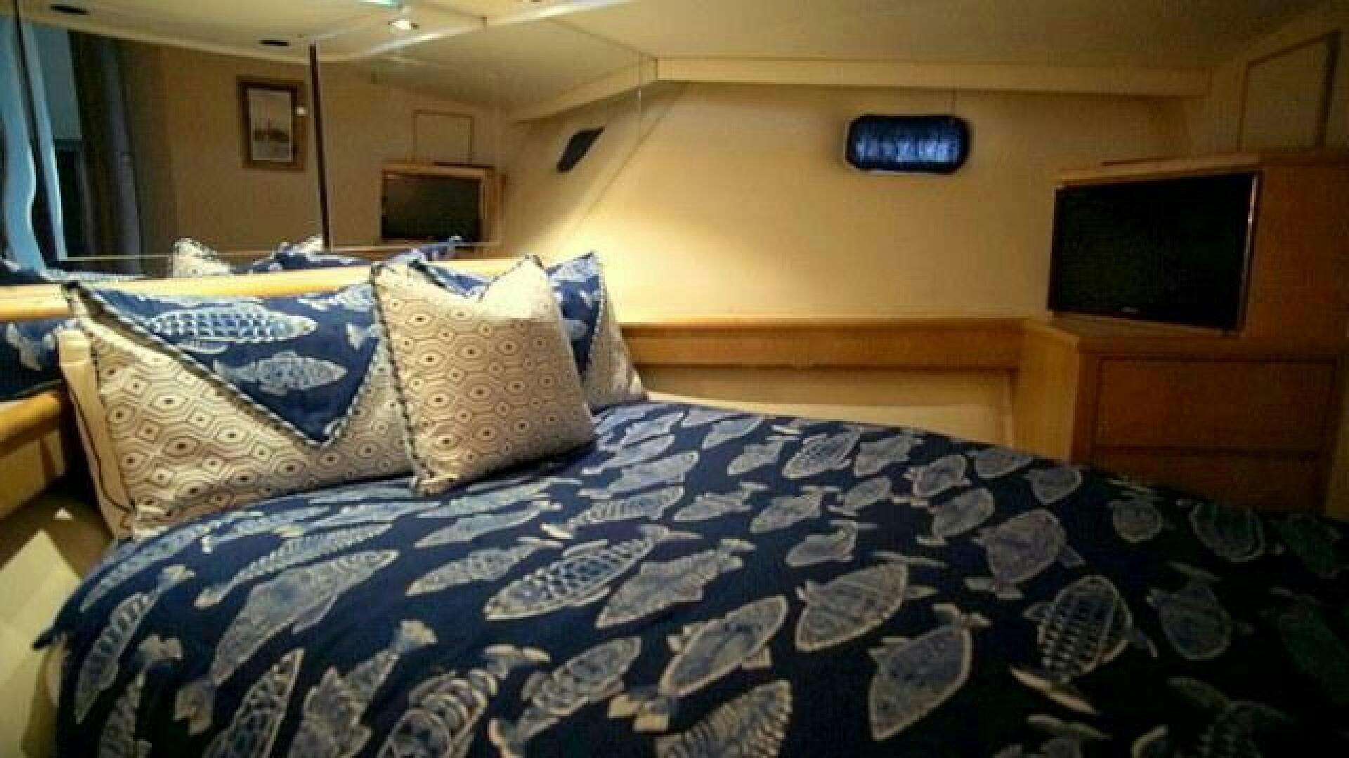 a bed with blue and white sheets aboard SILVER SEAS Yacht for Sale