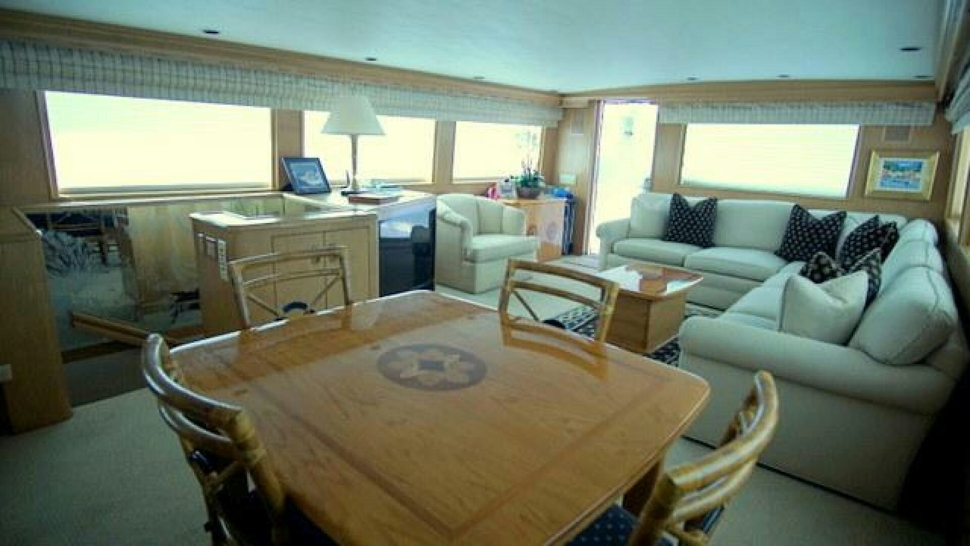 a living room with a table and couches aboard SILVER SEAS Yacht for Sale