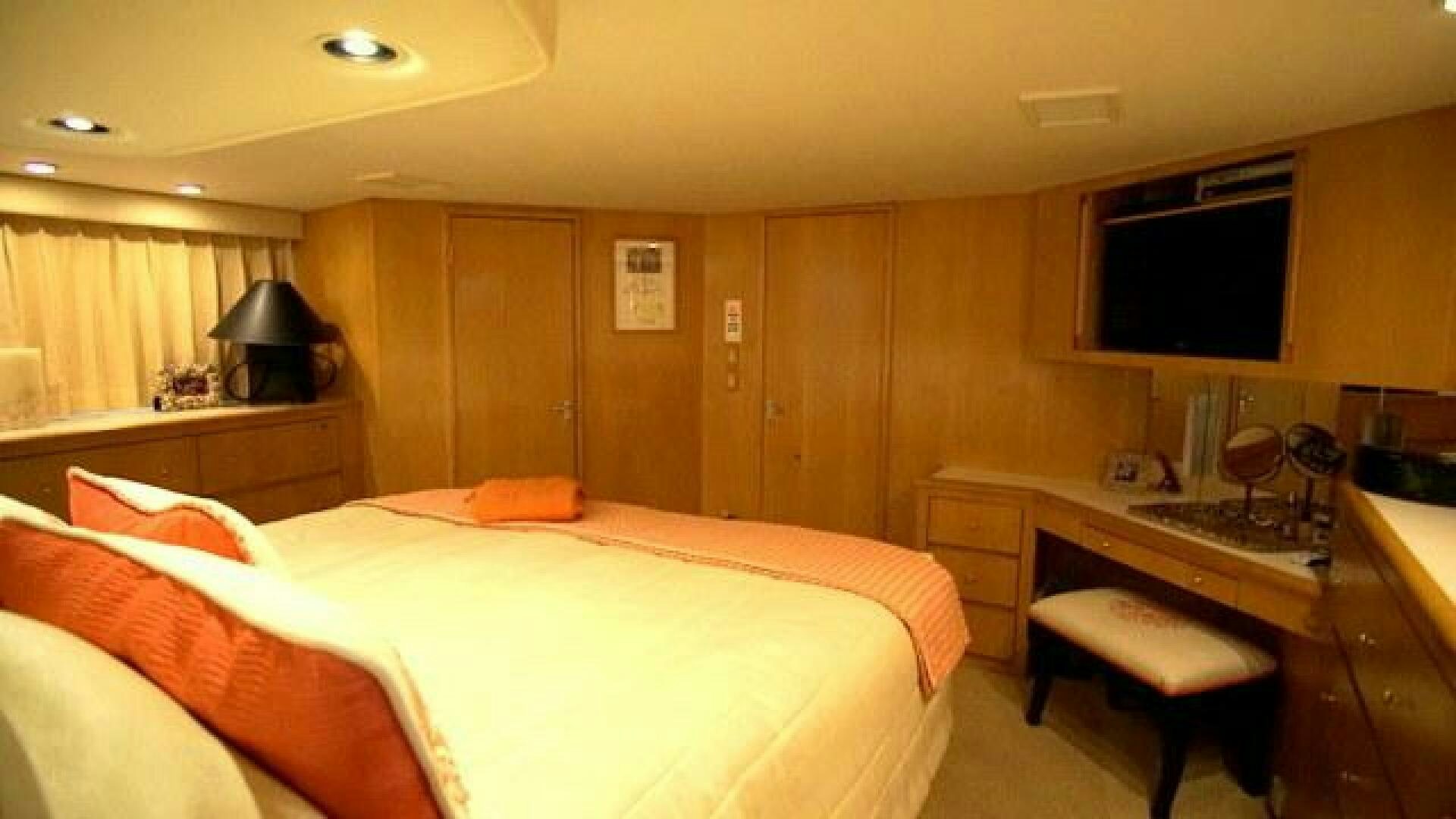 a bedroom with a bed and a desk aboard SILVER SEAS Yacht for Sale