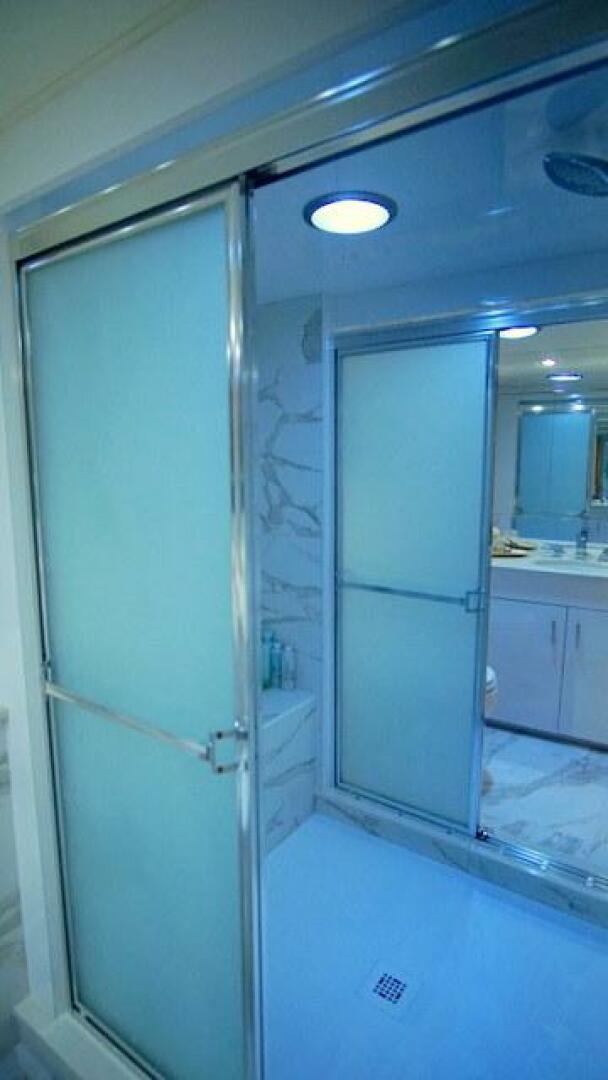 a bathroom with a glass shower aboard SILVER SEAS Yacht for Sale