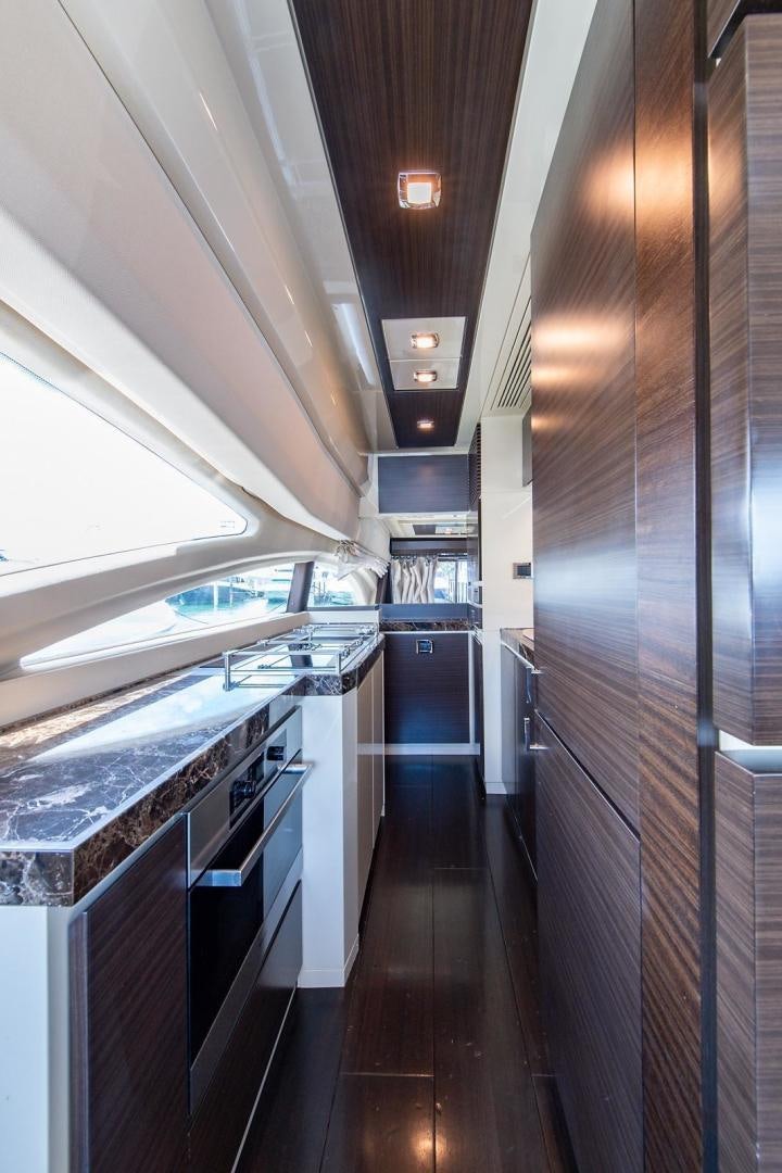 a kitchen with a large wood wall aboard SOMEWHERE I BELONG Yacht for Sale