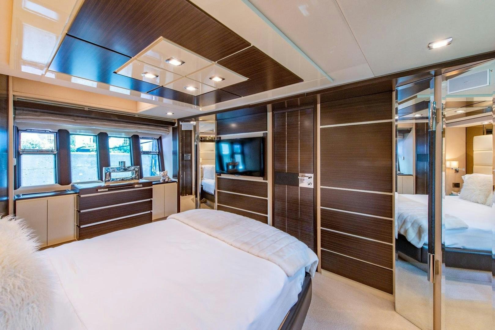a room with a bed and a tv aboard SOMEWHERE I BELONG Yacht for Sale