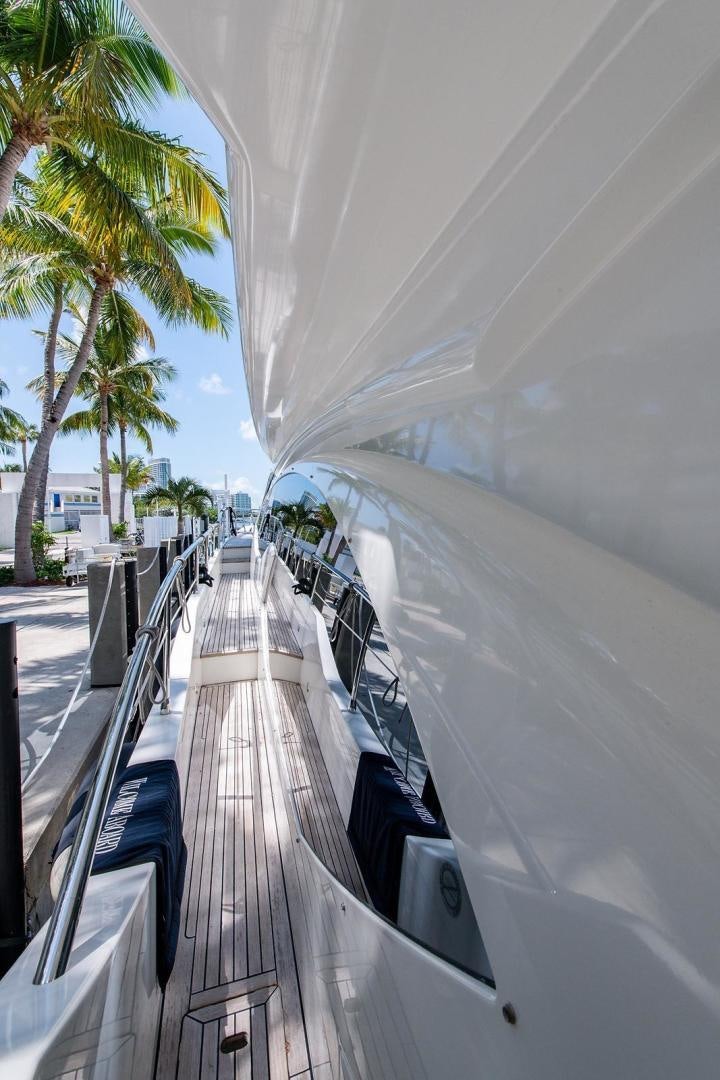 a long boardwalk with palm trees aboard SOMEWHERE I BELONG Yacht for Sale