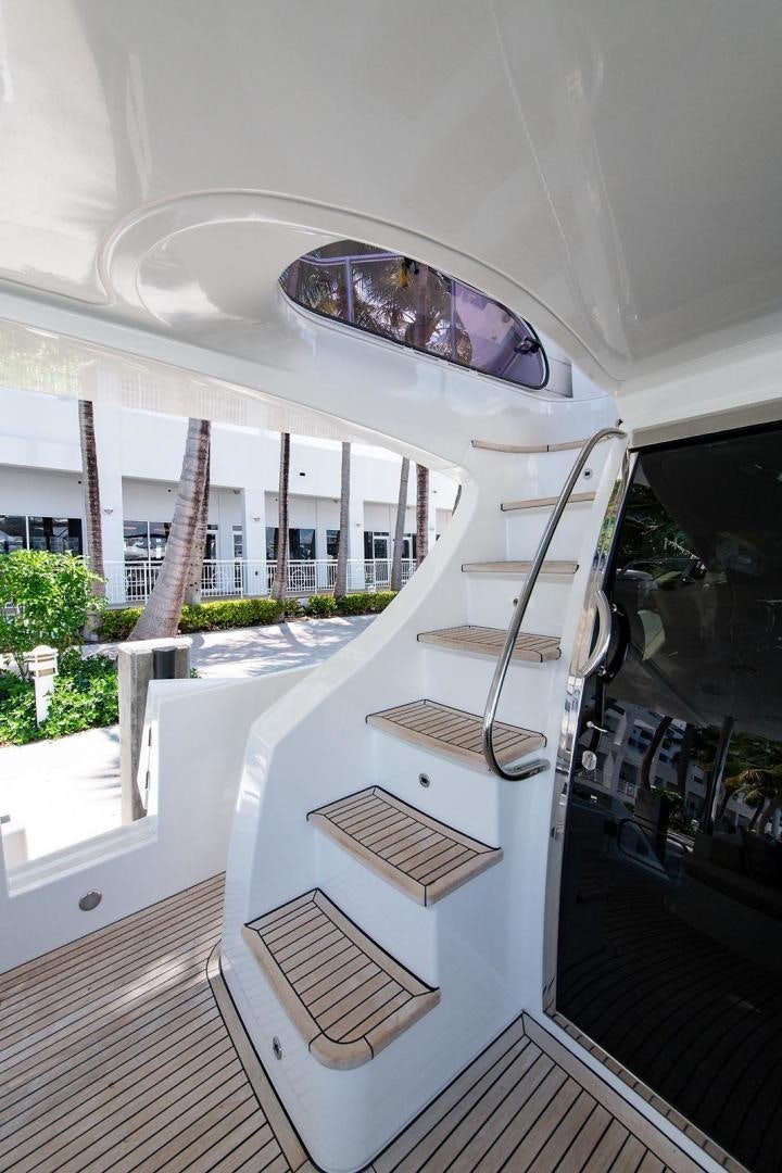 a white staircase with a glass ceiling aboard SOMEWHERE I BELONG Yacht for Sale