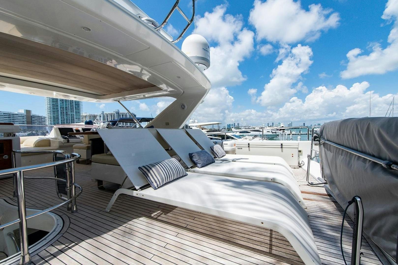a deck with a view of a city and a large body of water aboard SOMEWHERE I BELONG Yacht for Sale