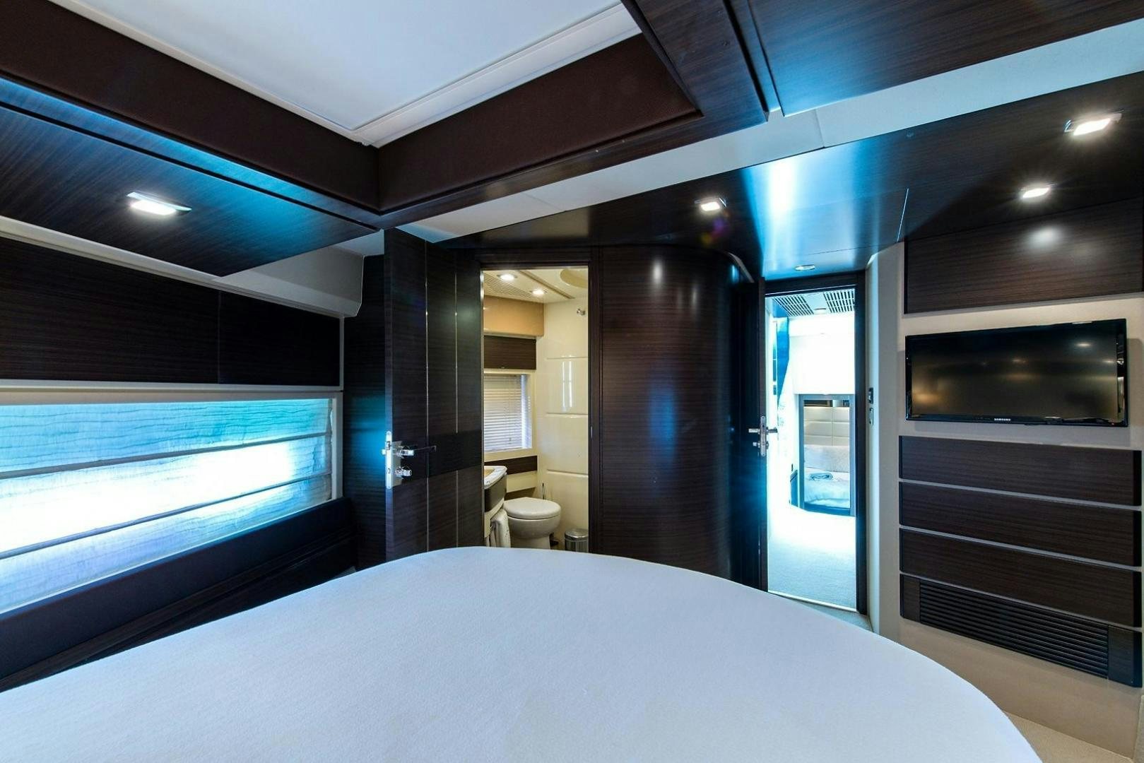 a room with a bed and a television aboard SOMEWHERE I BELONG Yacht for Sale