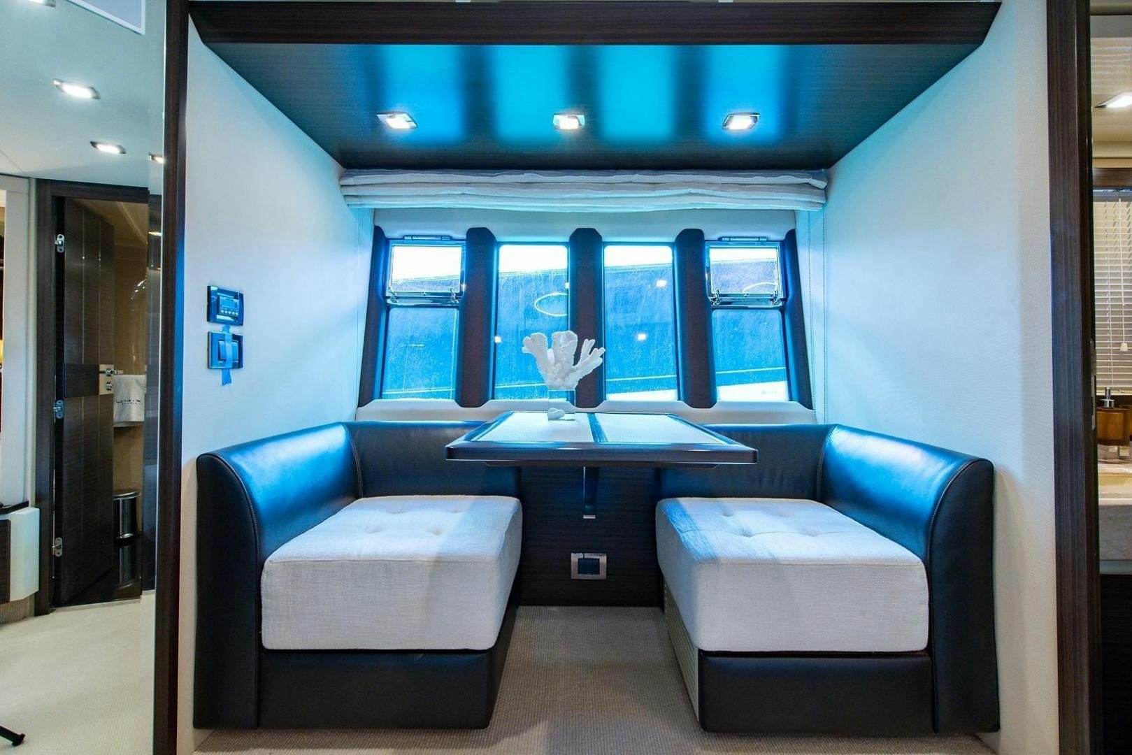 a room with a table and chairs aboard SOMEWHERE I BELONG Yacht for Sale