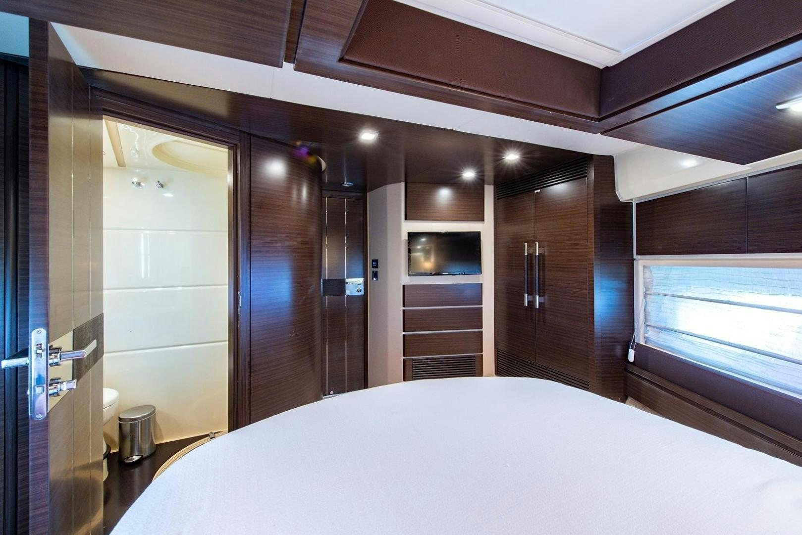 a room with a bed and a window aboard SOMEWHERE I BELONG Yacht for Sale