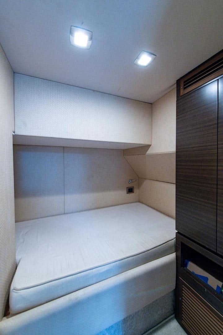 a room with a bed and cabinets aboard SOMEWHERE I BELONG Yacht for Sale