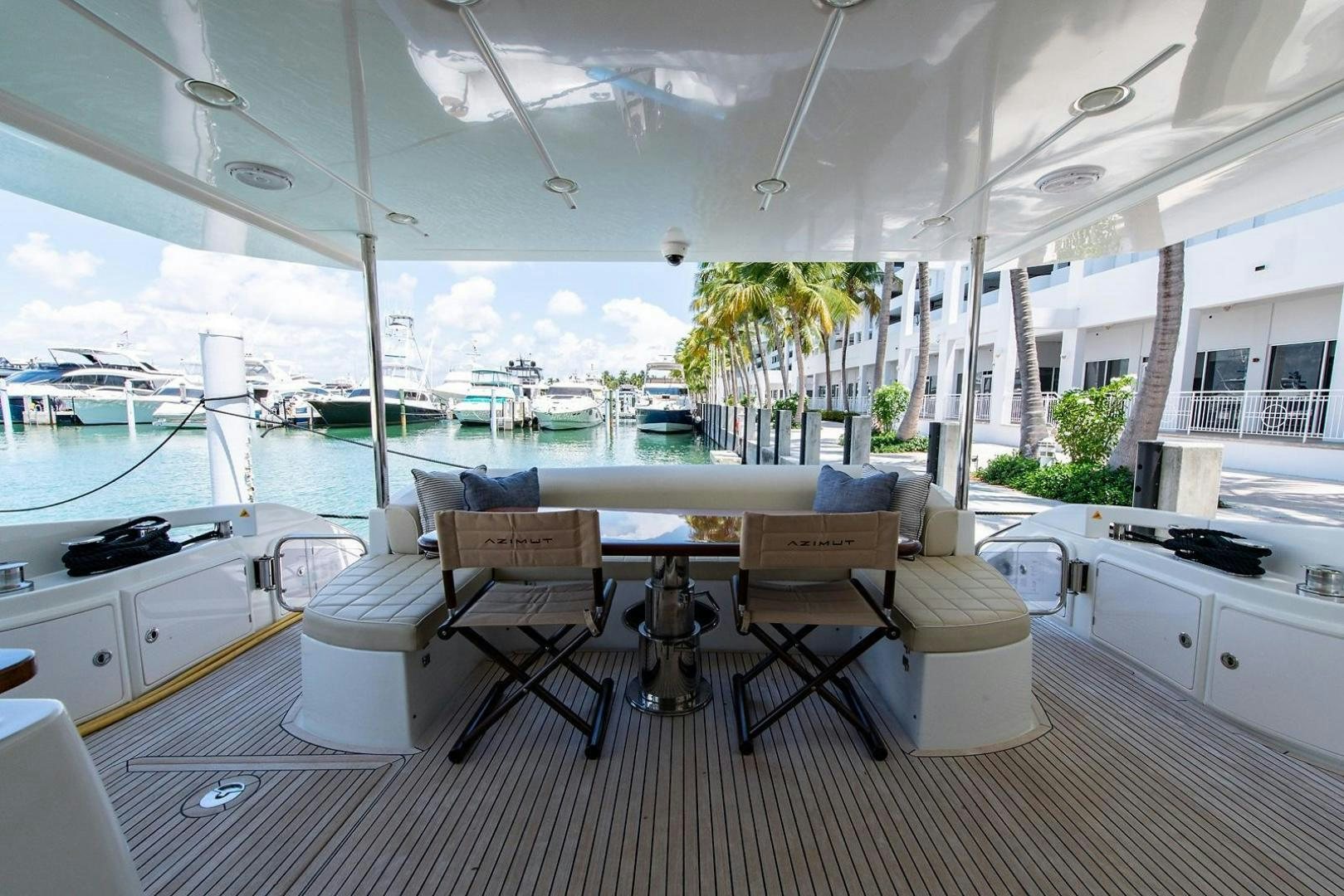 a room with a table chairs and a view of the water aboard SOMEWHERE I BELONG Yacht for Sale