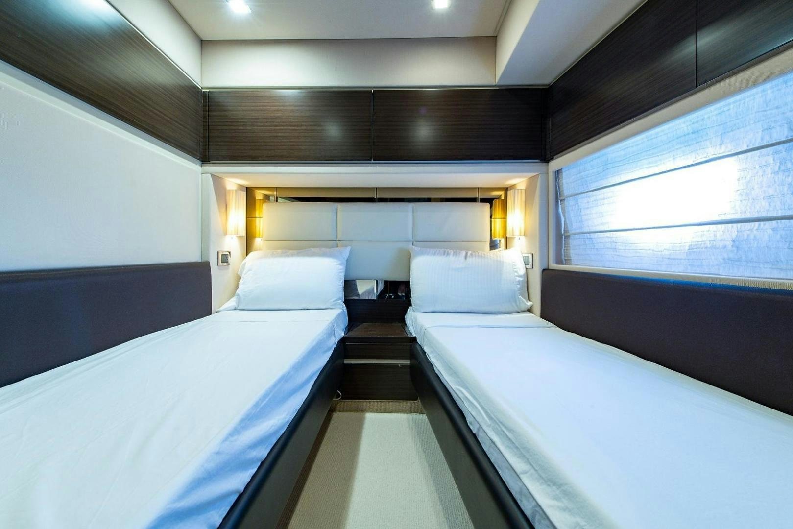 a room with beds and a window aboard SOMEWHERE I BELONG Yacht for Sale