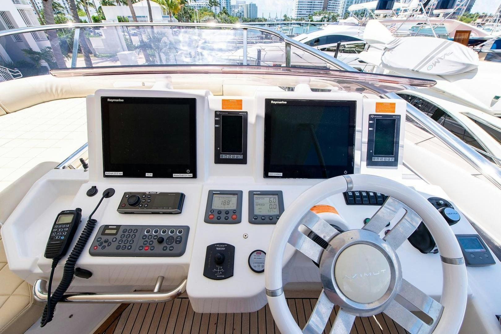 a white car with a screen and a remote control on the front aboard SOMEWHERE I BELONG Yacht for Sale