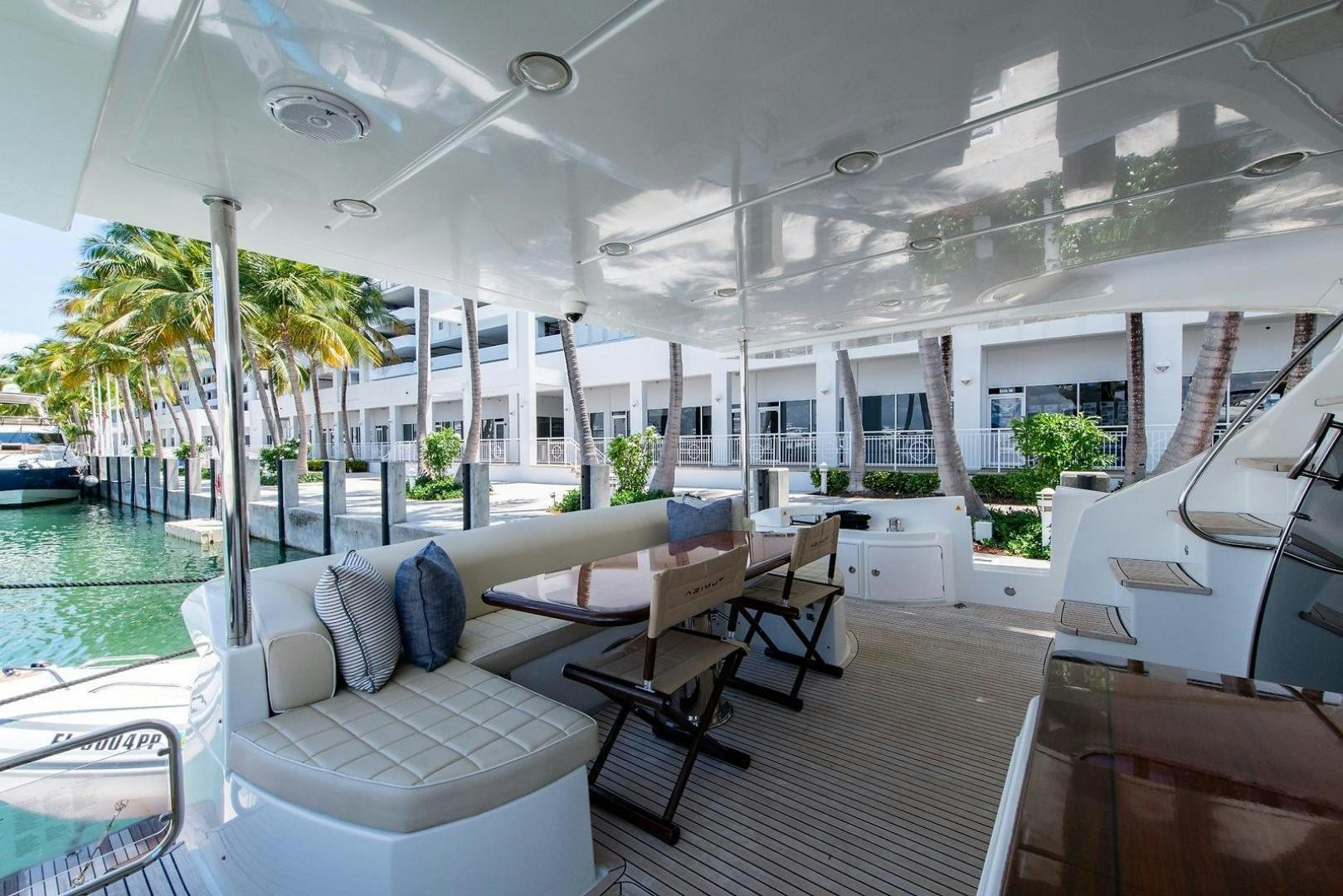 a room with a pool and lounge chairs aboard SOMEWHERE I BELONG Yacht for Sale