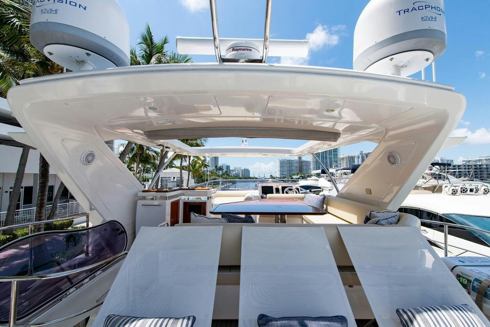 a large white boat with a large ship in the background aboard SOMEWHERE I BELONG Yacht for Sale
