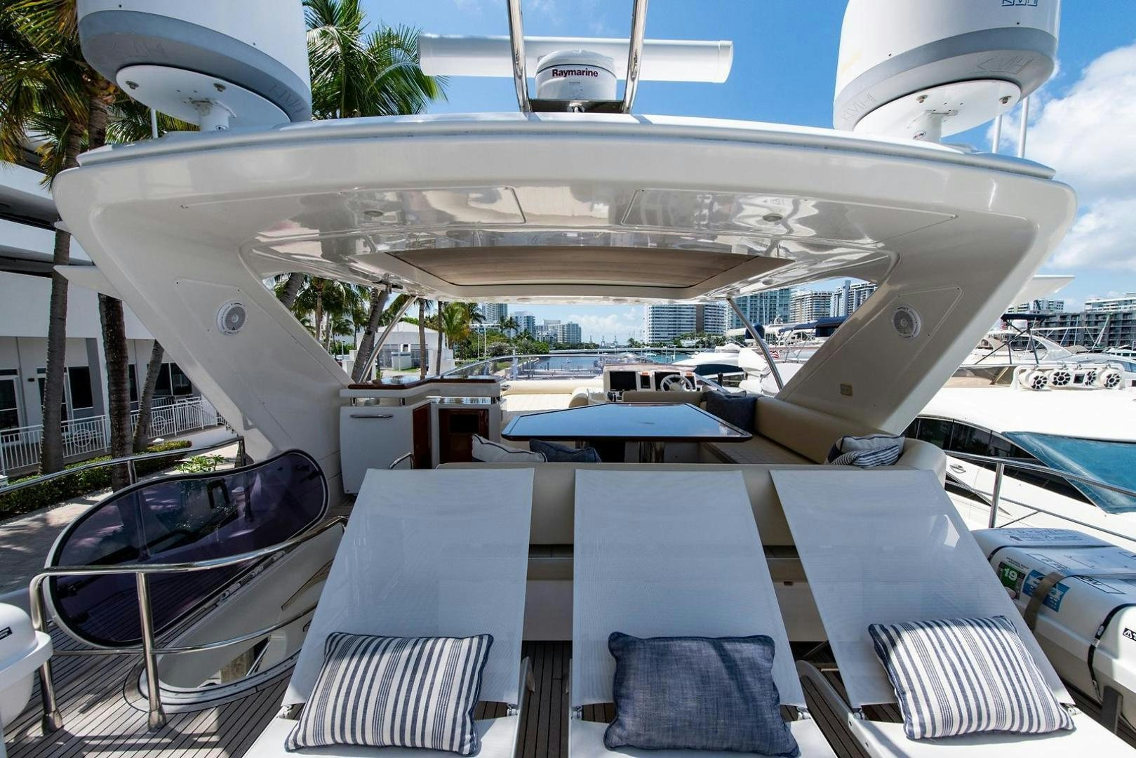 a deck with a pool and a boat in the water aboard SOMEWHERE I BELONG Yacht for Sale