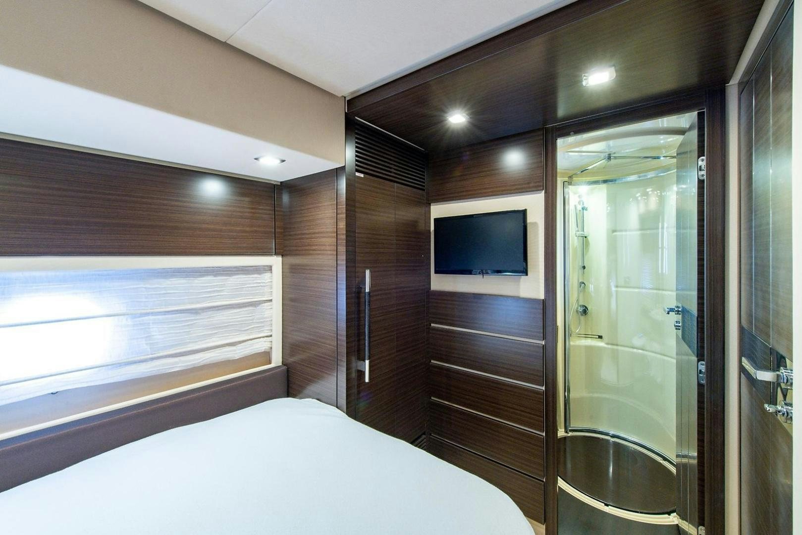 a bedroom with a bed and a television aboard SOMEWHERE I BELONG Yacht for Sale