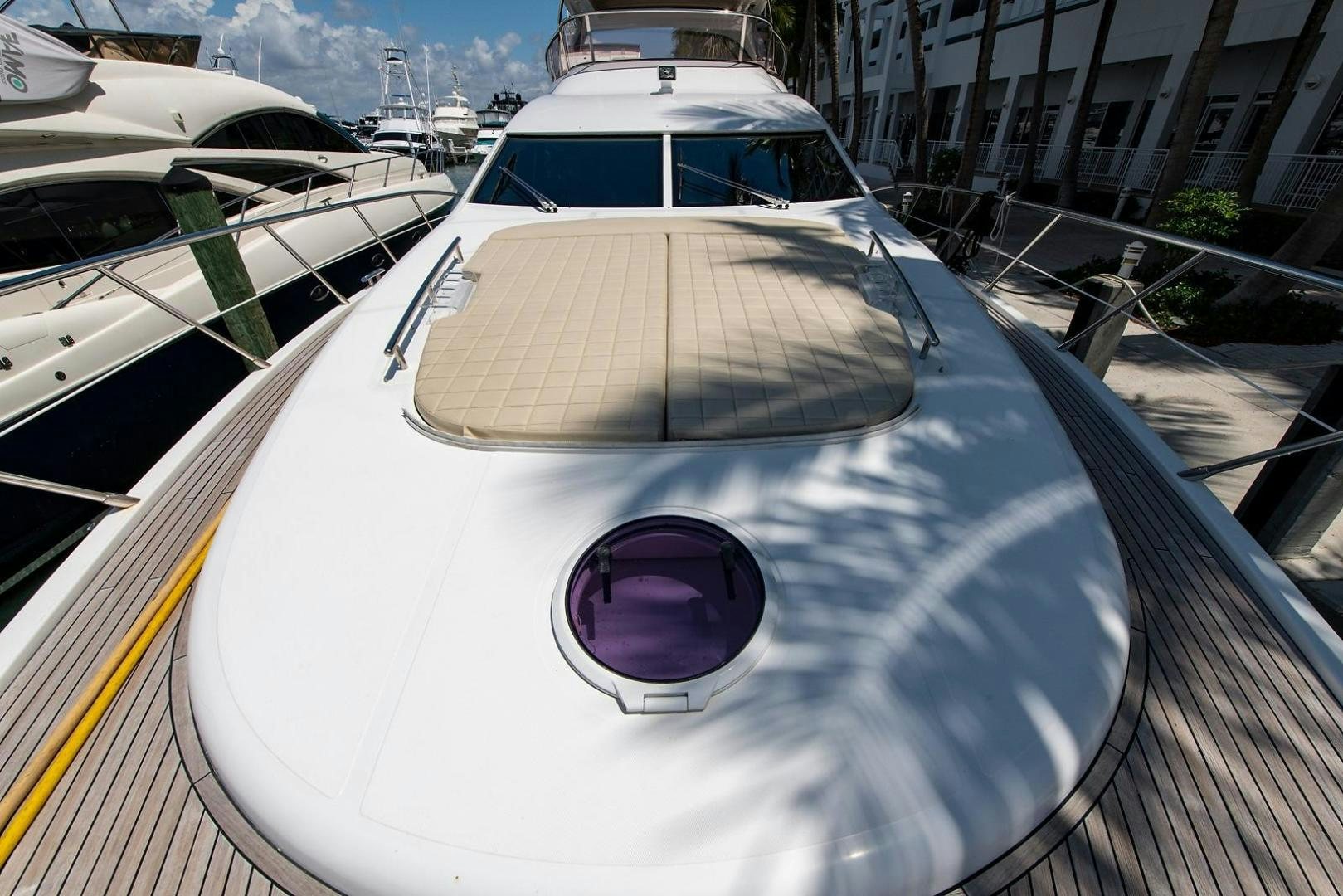 a white yacht on a dock aboard SOMEWHERE I BELONG Yacht for Sale