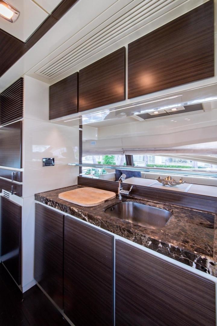 a kitchen with a sink and a large window aboard SOMEWHERE I BELONG Yacht for Sale