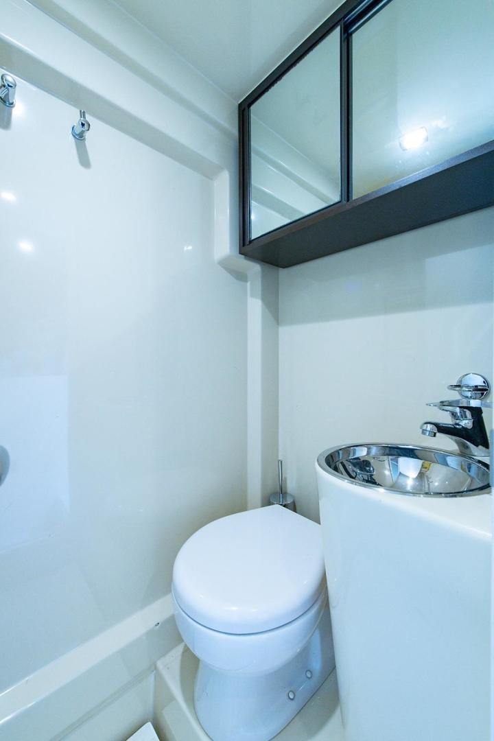 a bathroom with a toilet and sink aboard SOMEWHERE I BELONG Yacht for Sale