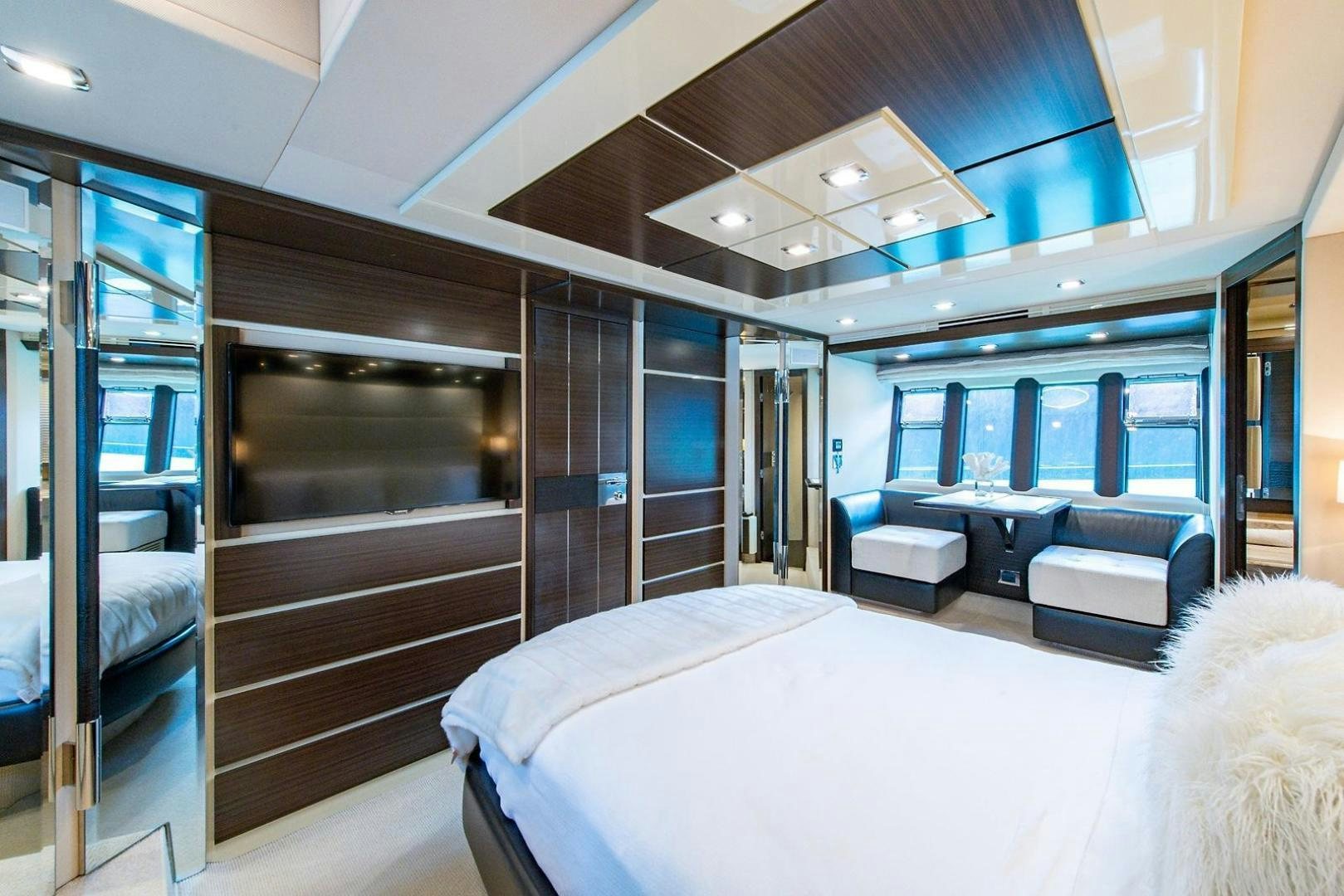 a room with a bed and a large window aboard SOMEWHERE I BELONG Yacht for Sale