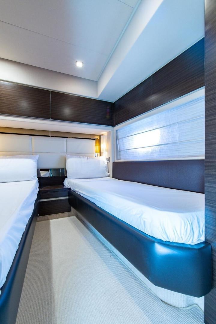 a room with a bed and a window aboard SOMEWHERE I BELONG Yacht for Sale