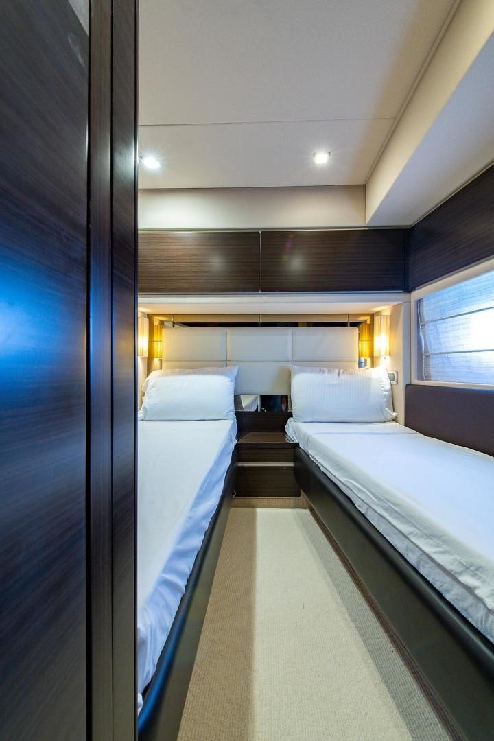 a room with a couple beds aboard SOMEWHERE I BELONG Yacht for Sale