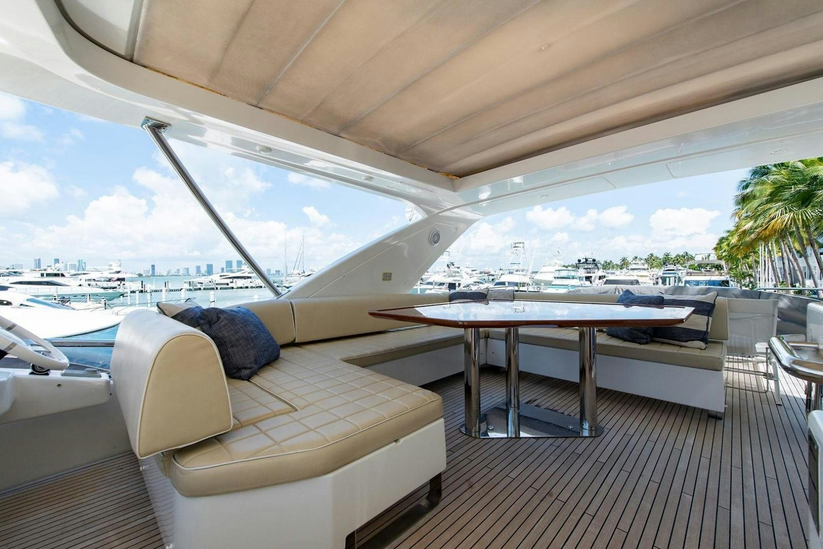 a deck with a pool and a deck with a view of the water aboard SOMEWHERE I BELONG Yacht for Sale