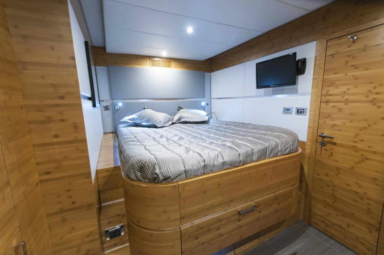 a room with a bed and a television aboard SKYLARK Yacht for Sale