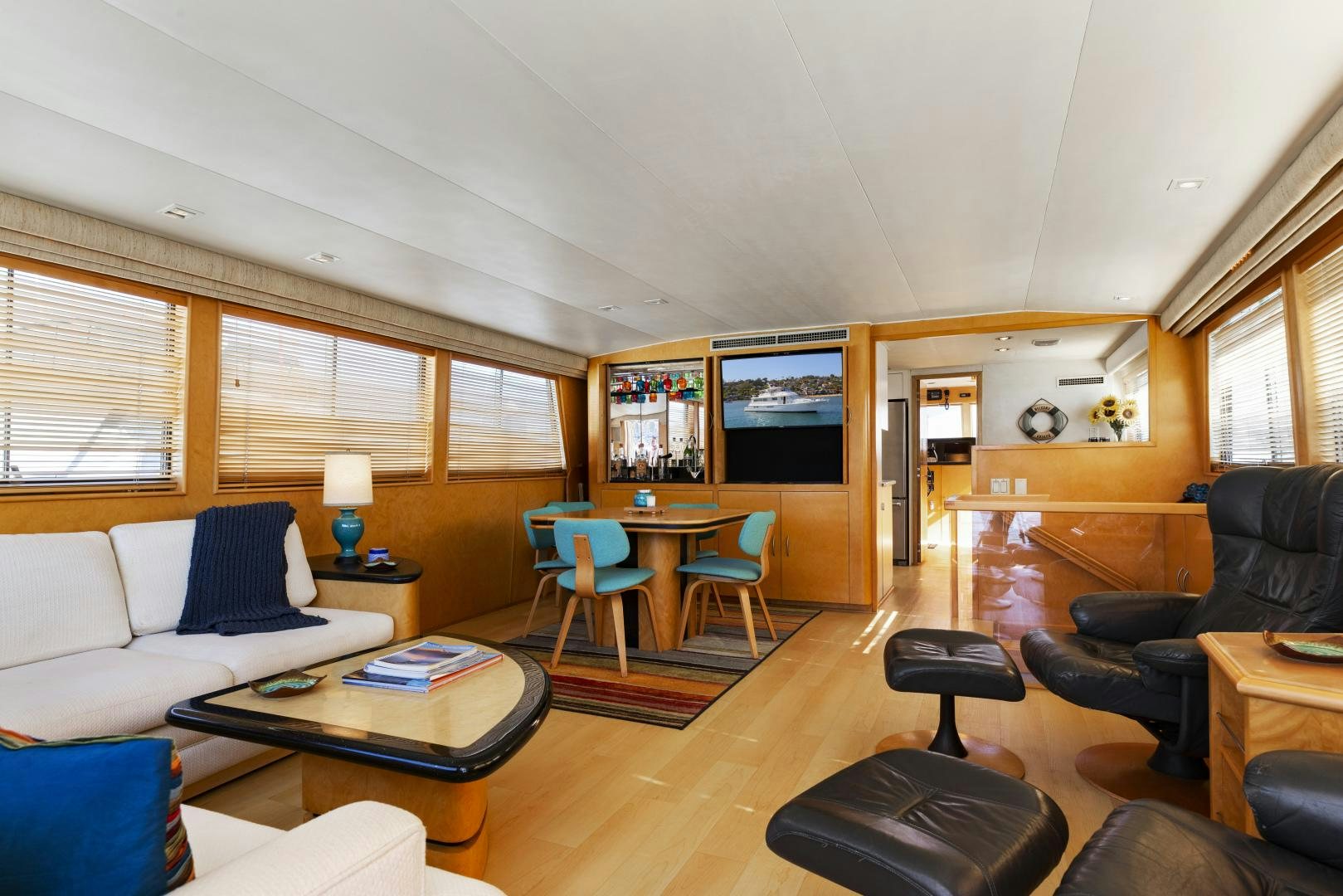 a living room with a couch and a television aboard DAYDREAMER IV Yacht for Sale