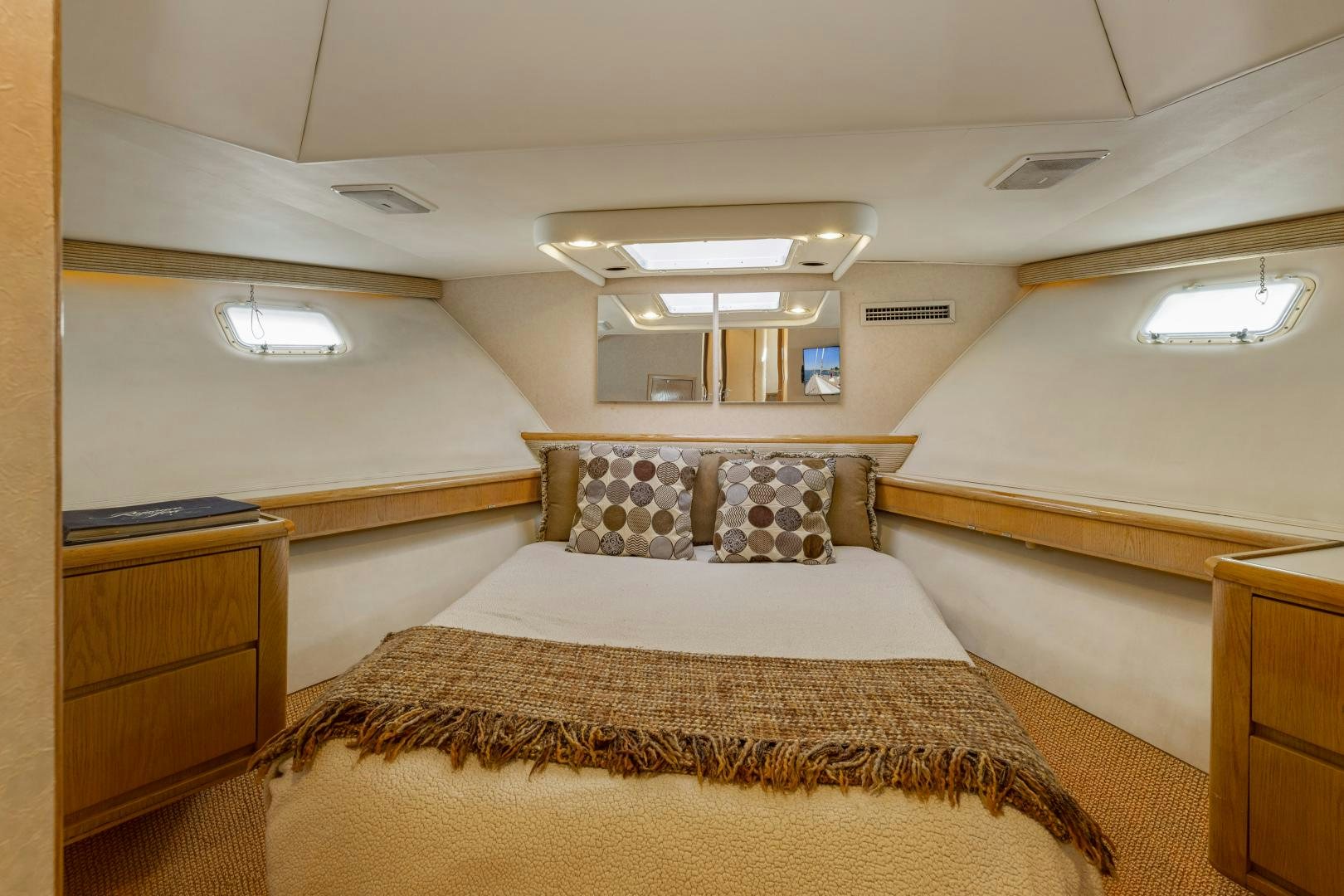 a bedroom with a bed and a desk aboard DAYDREAMER IV Yacht for Sale