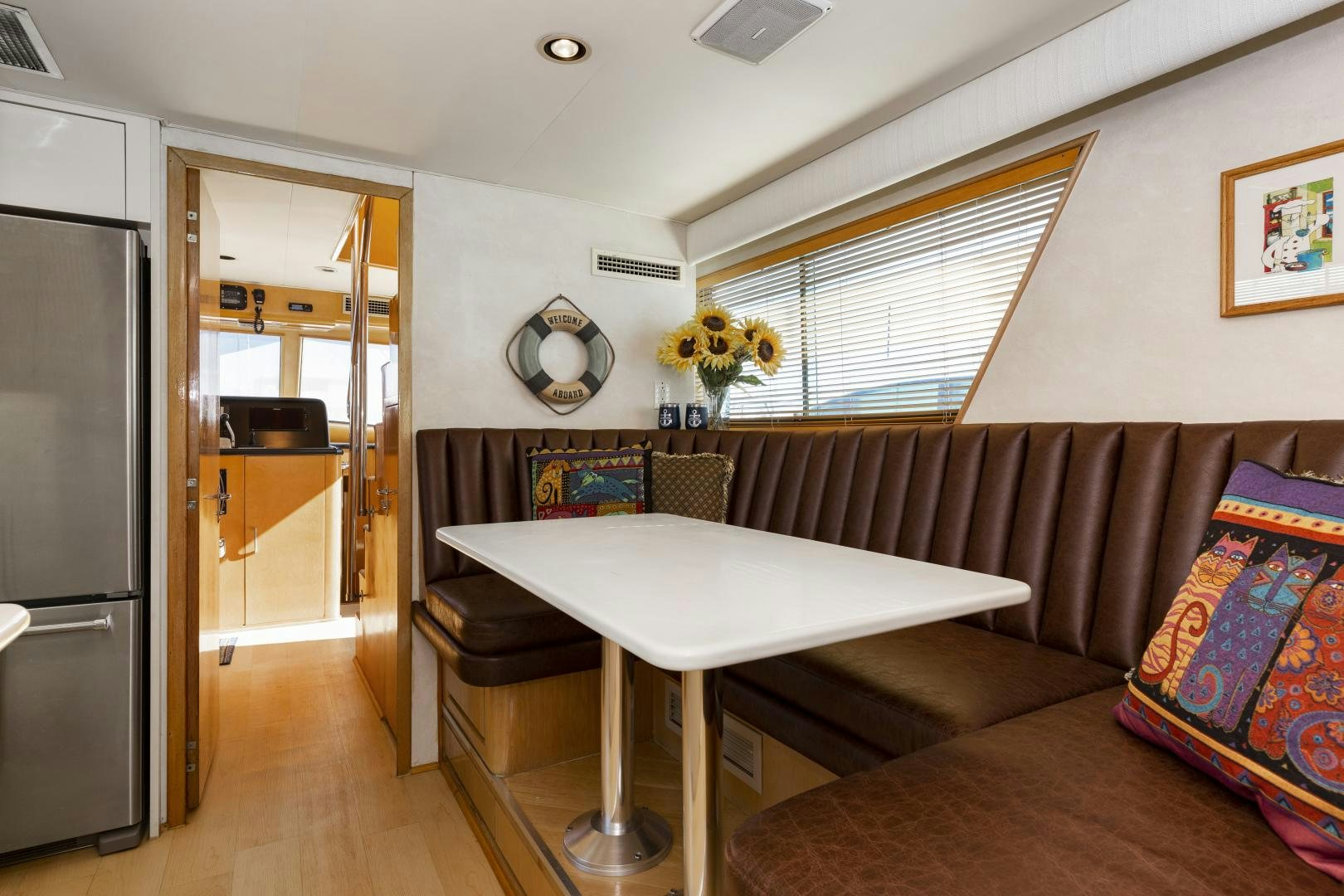 a room with a table and chairs aboard DAYDREAMER IV Yacht for Sale