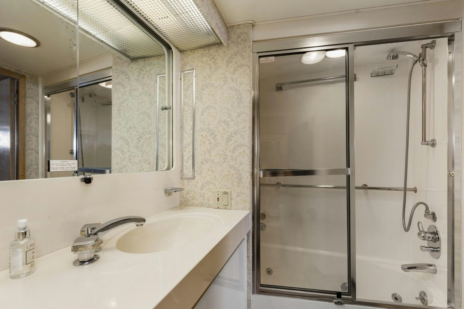 a bathroom with a shower unit and sink aboard DAYDREAMER IV Yacht for Sale