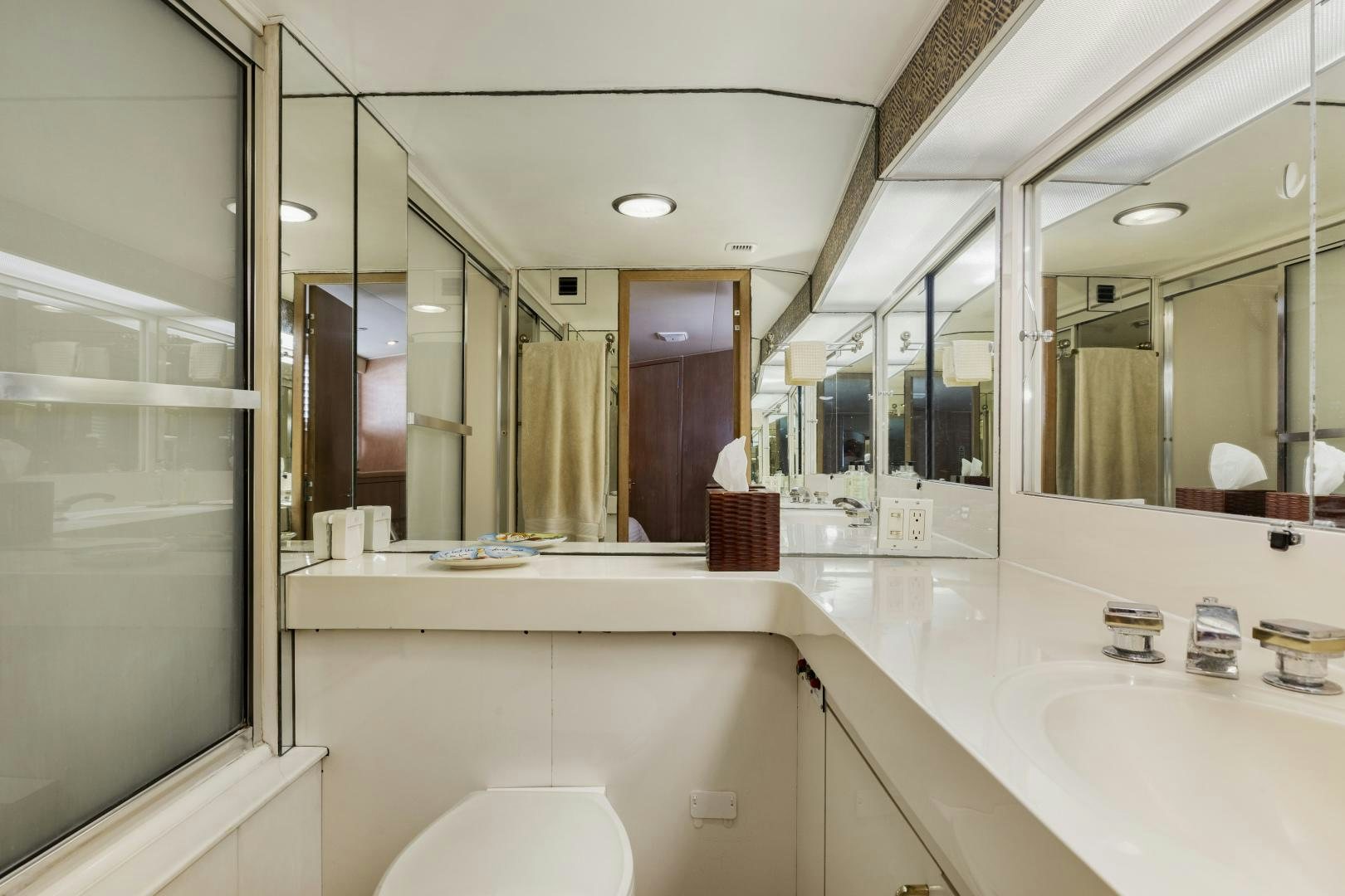 a bathroom with a large mirror aboard DAYDREAMER IV Yacht for Sale