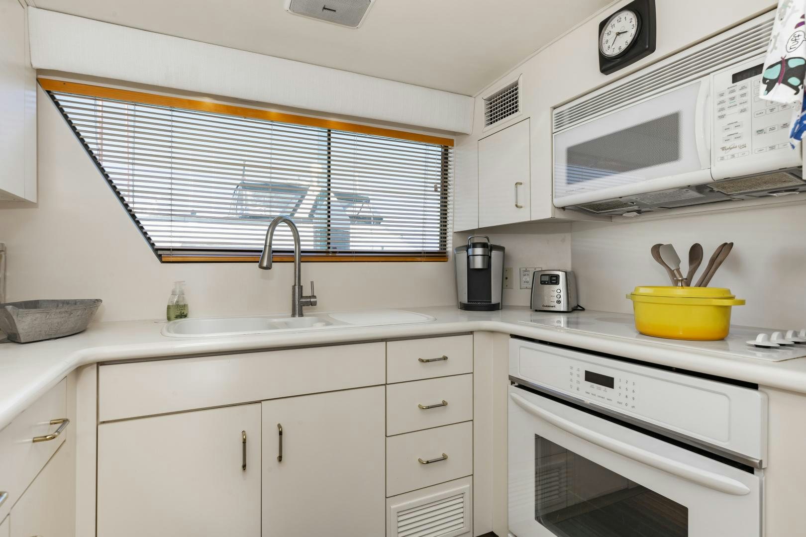 a kitchen with white cabinets aboard DAYDREAMER IV Yacht for Sale