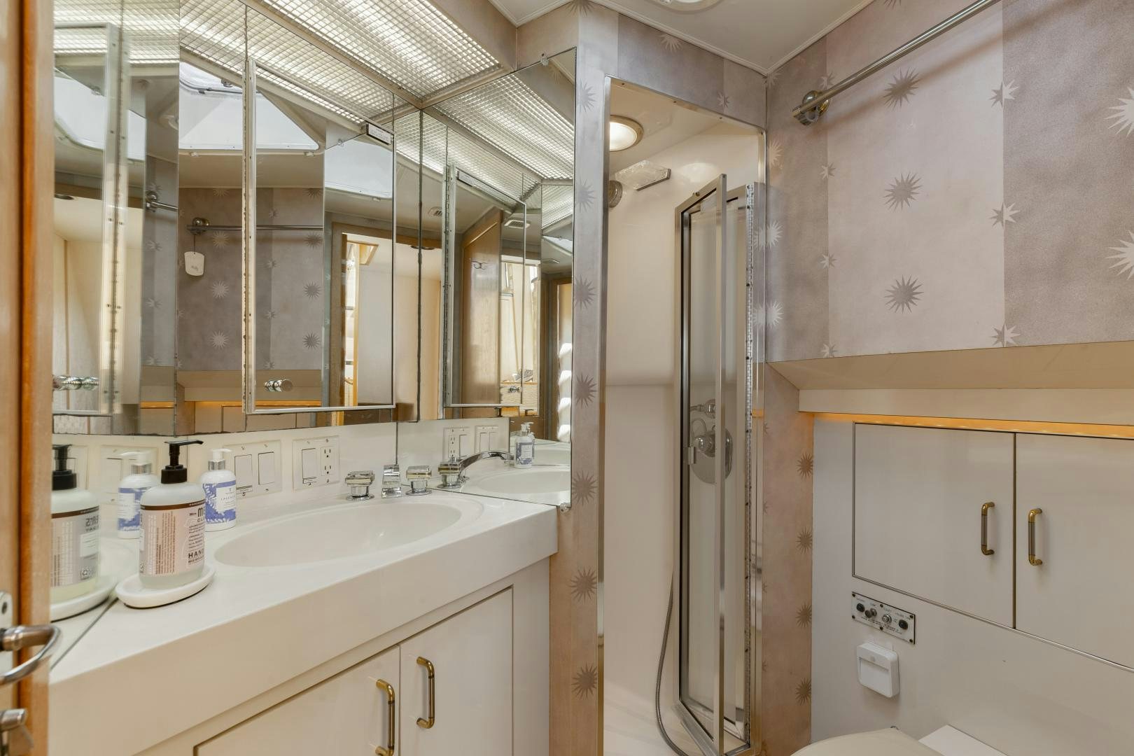 a bathroom with a sink and a mirror aboard DAYDREAMER IV Yacht for Sale