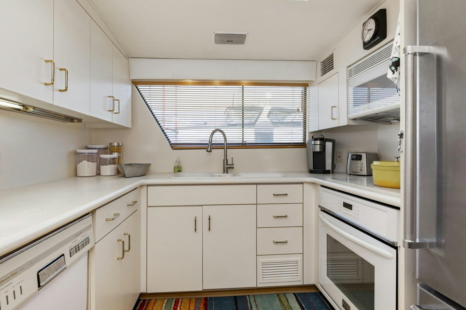 a kitchen with white cabinets aboard DAYDREAMER IV Yacht for Sale