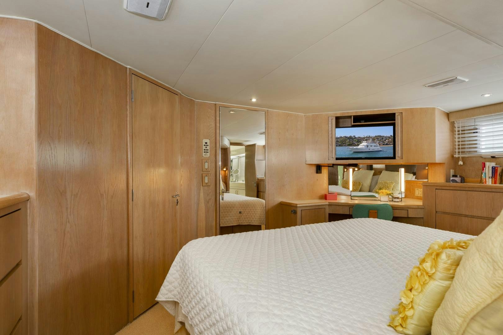 a bedroom with a bed and a tv on the wall aboard DAYDREAMER IV Yacht for Sale