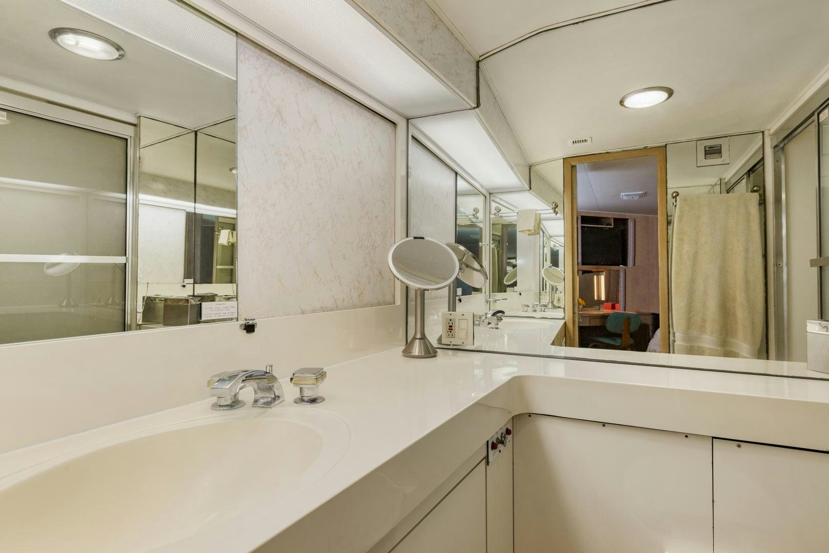 a bathroom with a large mirror aboard DAYDREAMER IV Yacht for Sale